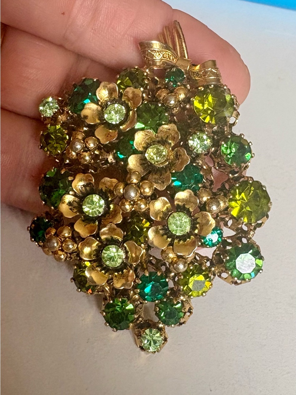 Gold Floral Pendant with Green Crystal Accents